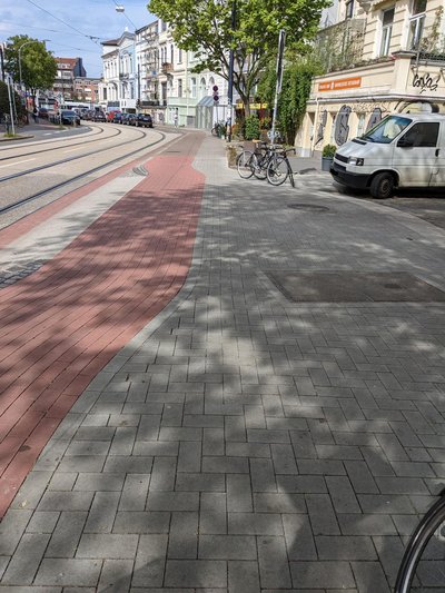 Hochpflasterung an Straßeneinmündung mit querendem Radweg
